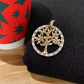 Detailed close-up of a gold tree of life brooch with sparkling crystal rhinestones - Tree of Life Gold Rhinestone Round