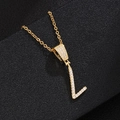 Macro shot of letter L pendant necklace with cubic zirconia paving on golden chain - L