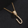 Macro view of gold-plated letter U pendant necklace with sparkling cubic zirconia inlay - Letter U