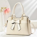 Off-white structured handbag with embossed pattern and decorative bow and gold hardware - White