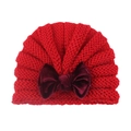 Red knit baby hat featuring a large deep red velvet bow on a clean white background - Red