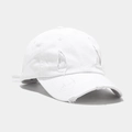 Detailed close-up of distressed white cotton baseball cap with vintage frayed hole details - White