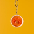 Realistic 3D crab soup food keychain with metal ring on vibrant yellow backdrop - King Crab