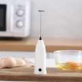 White handheld electric milk frother with stainless steel whisk on a wooden board - Blister Pack White