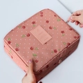 Pink travel makeup bag with cherry and polka dot patterns featuring a top zipper closure - Pink Cherry
