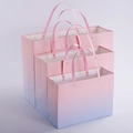 Pink and blue gradient gift bags in three sizes with gold rivets and ribbon handles - Gradient Color Rivet Style