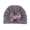 Purple knitted baby hat with a large velvet bow decoration on a white background - Gray