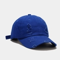 Macro detail of distressed baseball cap fabric with vintage torn holes and cotton texture - Blue