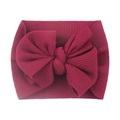 Close-up of wine red knitted baby headband with a large bow on white background - Burgundy