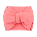 Soft pink textured fabric baby headband with a large decorative bow on white background - Pink