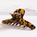 Close-up of tortoiseshell acetate hair claw clip showing polished leopard pattern and sturdy teeth - S138-6 Dark Tortoiseshell