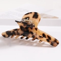 Detail of tortoiseshell acetate hair claw clip showing polished texture and metal spring - S138-5 Amber Tortoise