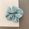 Solid light blue fabric scrunchie with twill texture on a vintage book - Light Blue