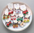 Detailed set of Christmas hair ties with Santa, tree, and reindeer charms on white tray - Mixed Christmas Styles