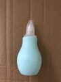 Manual baby nasal aspirator in light blue silicone with protective cap and soft suction tip - Green