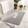 Gray rectangular plush bath mat with Bath text on a modern marble bathroom floor - 40x60cm / Smoke