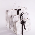 Three-piece geometric pattern gift bags with black satin bows and metal reinforcements - Geometric Triangle With Bow Rivet Style / Small 28*20*10CM