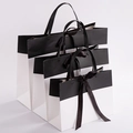 Three-piece set of black and white cardboard gift bags with ribbon bows in various sizes - Black & White Color Block With Bow Rivet Style