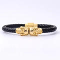 Pulsera de cuero trenzado negro para hombre con calaveras doradas y cierre magnético - Doble Calavera / Dorado