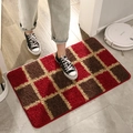 Red and brown checkered plush door mat being stepped on in a modern home entryway - 40x60cm / Mosaic