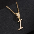 Close-up of golden letter I pendant featuring shimmering micro-paved cubic zirconia stones - Letter I