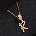 Detailed close-up of a golden R-shaped letter pendant with sparkling zircon micro-paving - Letter R