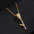 Detail of gold letter Y pendant necklace with micro-pave crystals on black background - Letter Y
