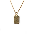 Close-up of gold copper necklace featuring a rectangular pendant with engraved letter K - Letter K