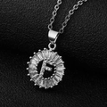 Macro detail of silver-tone letter F pendant with cubic zirconia sunburst setting - Silver Letter F