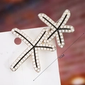 Macro detail of starfish-shaped hair clips with pearls and gold trim on 7cm metal base - S192-3 Pearl Starfish Double Hair Clip