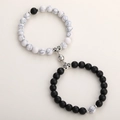 Macro detail of natural stone couple bracelets with magnetic ball clasp and alloy beads - Howlite & Black Matte Set