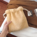 Close-up of soft beige fleece drawstring pouch showing plush texture and white cord - Light Camel