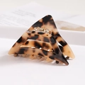Macro shot of amber tortoiseshell acetate hair claw with hollow triangular design - S140-5 Triangle Amber Tortoise