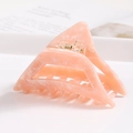 Detail view of pink marble acetate triangular hair claw clip with golden metal spring - S140-4 Triangle Pink Orange Marble