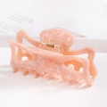 Detail of pink marble acetate hair claw clip with golden metal spring and multi-tooth design - S141-4 Pink & White Marble