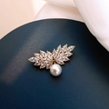Close-up of golden leaf brooch with sparkling marquise crystals and a white pearl - X0288 Angel Wings