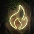 Flame-shaped LED neon sign with warm yellow glow on a white mesh decorative grid - 1-2W / Flame Warm White