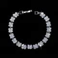 Macro detail of silver plated floral bracelet featuring sparkling zircon flower links - 17.6cm / White