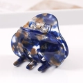 Detailed close-up of blue marble pattern acetate hair claw clip with golden spring - S136-10 Bow Blue Brown Mix