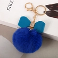Close-up of royal blue faux fur pompom keychain with a turquoise bow and rhinestone detail - Royal Blue - Litchi Bow