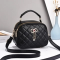 Elegant black quilted crossbody bag with golden hardware and tassel bow accessory - Black