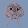 Detailed macro view of purple knit dinosaur hat texture and protective earflaps - Gray
