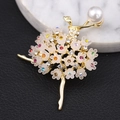 Detailed close-up of ballerina brooch with pearl head and colorful crystal tutu floral skirt - Dancing Ballerina Gold