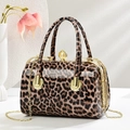 Glossy leopard print handbag with gold chain strap and pearl clasp on white background - Khaki