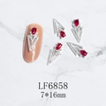 Macro view of 3D triangle nail art charm with red teardrop gem and silver alloy base - Silver Red Gem Style (6858)
