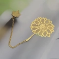Golden brass bookmark with hollow sunflower design and maple leaf pendant detail - Sunflower