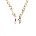 Close-up of golden necklace featuring a chunky chain and colorful rhinestone letter H pendant - Letter H