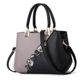 Chic grey and black leather handbag featuring floral embroidery and gold-tone hardware - Classic Grey