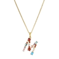Detailed close-up of gold letter M necklace featuring vibrant multicolor gemstone pavé setting - M