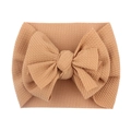 Close-up of beige baby headband with large bow in soft elastic ribbed fabric texture - Coffee